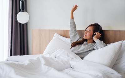 Young woman sleeping on bed at home