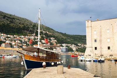 Boats moored at harbor