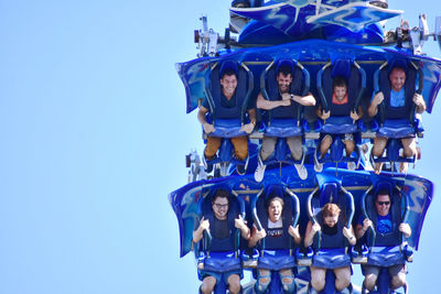 High angle view of people standing against blue sky