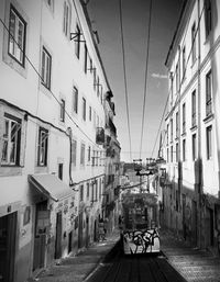 Street amidst buildings in city against sky