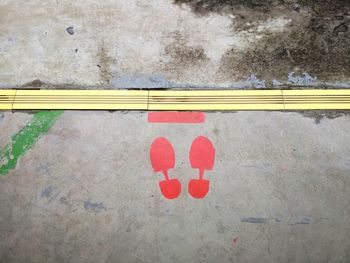 High angle view of text written on road against wall