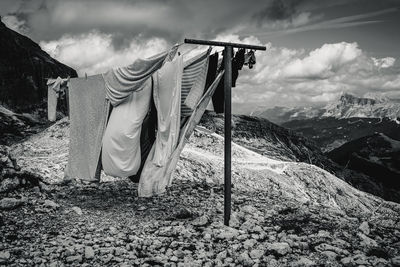 Clothes drying on clothesline on field against sky