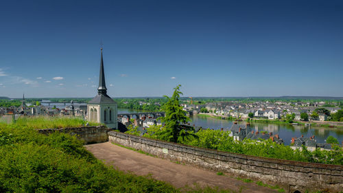 Panoramic view of buildings against blue sky