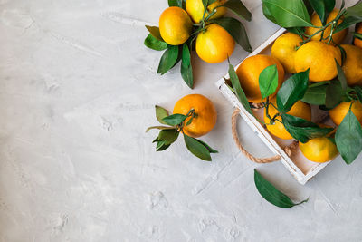 High angle view of fruits and leaves on table