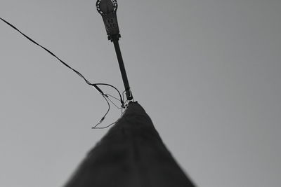 Low angle view of silhouette pole against clear sky