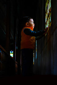 Side view of man looking up at night