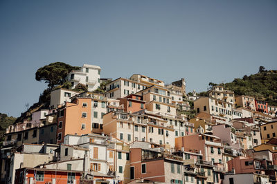 Buildings in town against clear blue sky