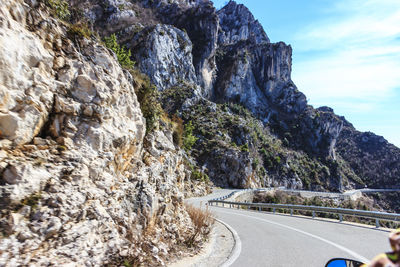 Road by mountain against sky