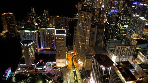 High angle view of illuminated buildings in city at night