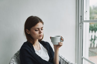 Young woman drinking coffee cup