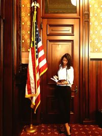 Woman standing by door at home