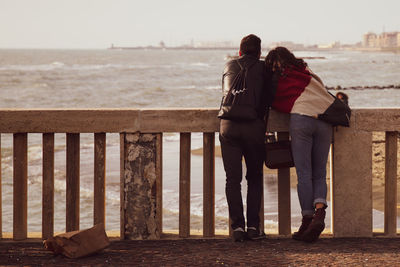Rear view of couple kissing in water