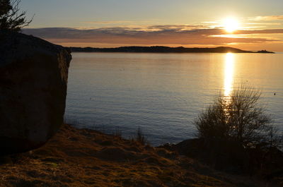 Scenic view of sunset over lake