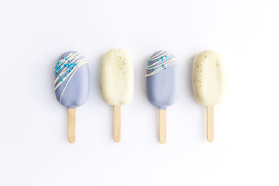 High angle view of candies against white background