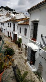 High angle view of footpath amidst buildings in city