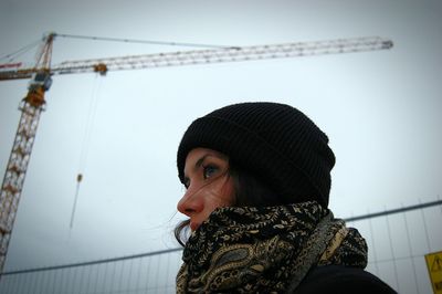 Close-up of woman against crane