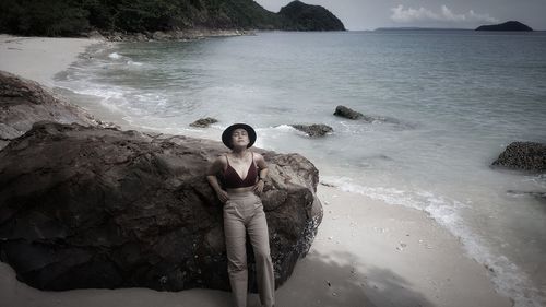 Full length of man on rock at beach