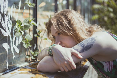 Close up thoughtful woman resting on crossed arms portrait picture