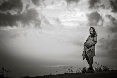 Low section of woman standing on land against sky