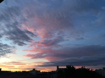 Low angle view of silhouette city against sky