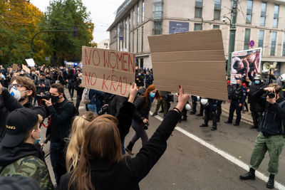 Group of people on road along buildings