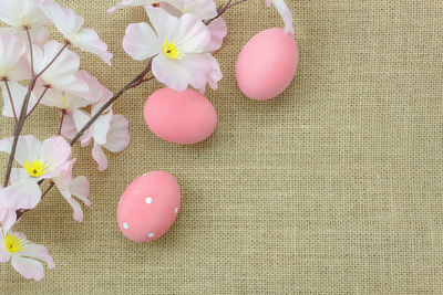 High angle view of pink easter eggs with flowers on table