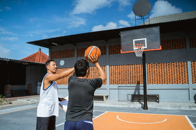 Basketball players playing on court