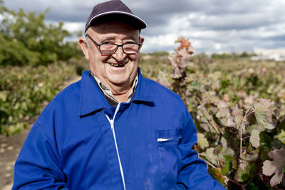 Portrait of man wearing sunglasses standing on field