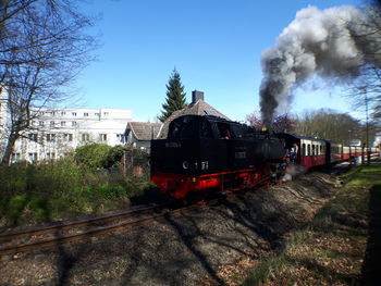 Train on railroad track against sky