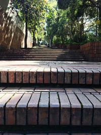 View of brick wall with trees in foreground