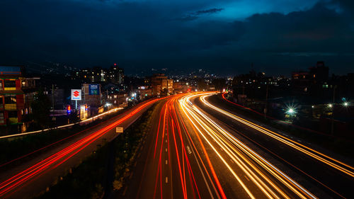 High angle view of light trails on road at night