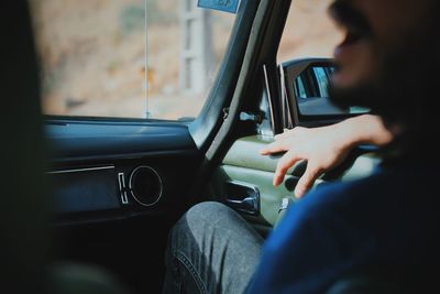 Close-up of man sitting in car