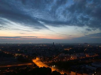 High angle view of illuminated buildings in city at sunset