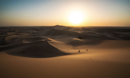 Scenic view of desert against sky during sunset