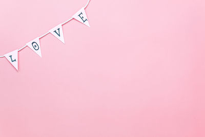 Love text bunting on pink background