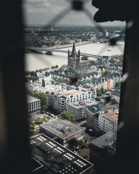 High angle view of city buildings seen through window