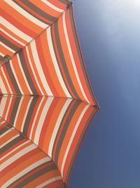 Low angle view of multi colored umbrellas against sky