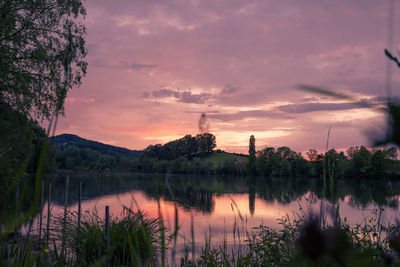 Scenic view of lake against sky during sunset