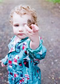 Cute baby girl standing outdoors