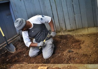 High angle view of man working on wall