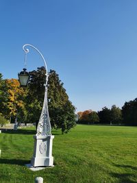 Information sign on field against clear sky