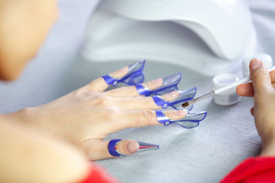 Close-up of hands holding blue purple