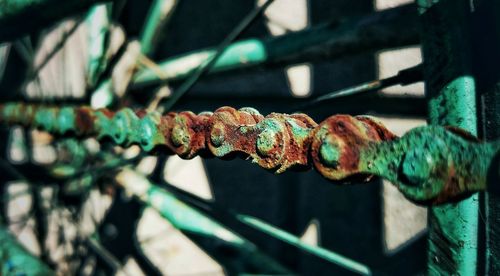 Close-up of rusty metal chain against wall