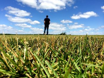 Scenic view of field against cloudy sky