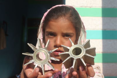 Close-up portrait of a girl holding camera