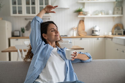 Portrait of young woman using mobile phone