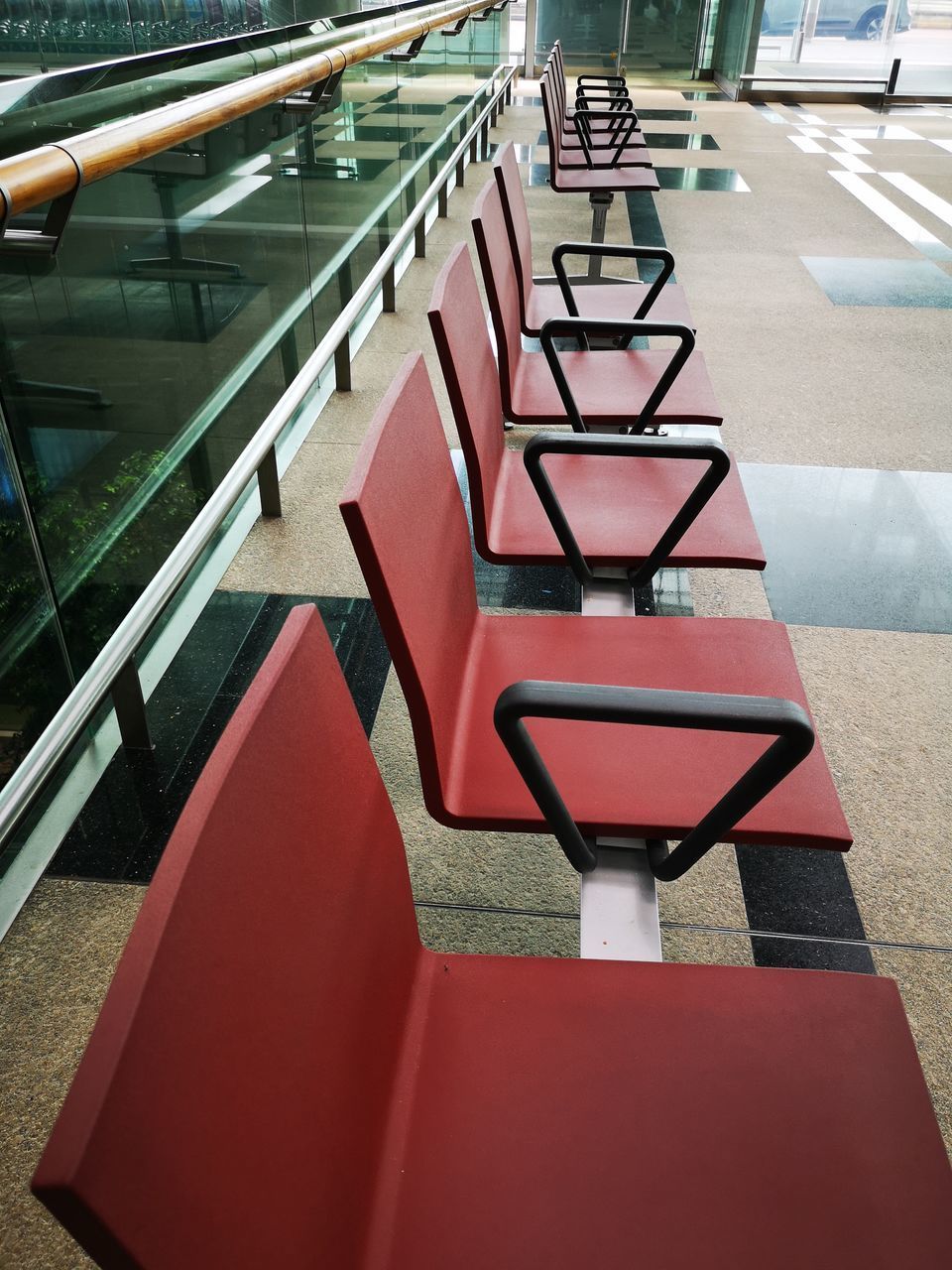 HIGH ANGLE VIEW OF EMPTY CHAIRS AND TABLES IN ROW