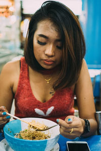 Portrait of young woman holding ice cream
