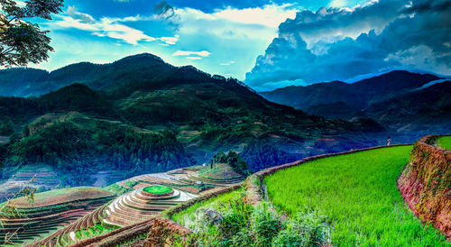 Scenic view of mountains against cloudy sky