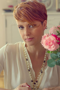 Close-up of young woman with rose bouquet